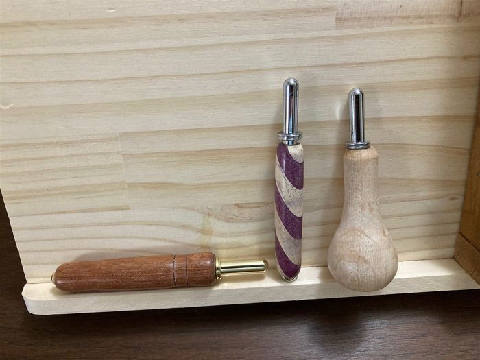 Three seam rippers with different turned handles